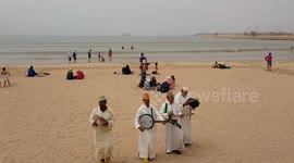 Morrocan old man traditional band performing on the beach