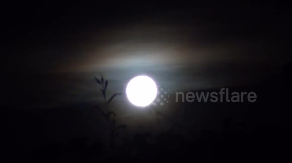 Colorful clouds around the Moon. Beautiful timelapse 