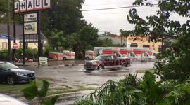Trucks and cars driving through heavy rain flooding New Orleans
