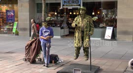 Street entertainer appears to float in air