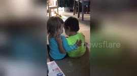 Adorable 2 year old comforts her twin brother