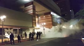 Armed police fire tear gas at anti-Trump protesters