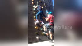 Woman with cerebral palsy conquers climbing wall
