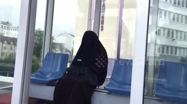 Muslim woman with burqa using her mobile phone in Paris