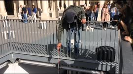 Ingenious men use magnets on strings to fish coins from wishing well