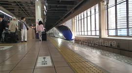 Shinkansen train pulling in in Omiya station Japan May 9th 2016 platform bullet high speed shiny