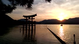 Giant red tori gate Hiroshima itsukushima miyajima Japan pretty sunset island mountains