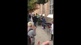 Catalan voters applaud arrival of local police at polling station