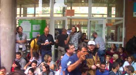 People sit on the floor to prevent the police from going over