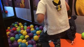 Slow motion jump into a ball pitt