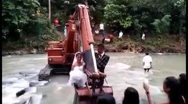 Over the threshold: Newlyweds carried across floods in digger