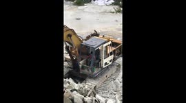 Six-year-old boy operating digger on building site