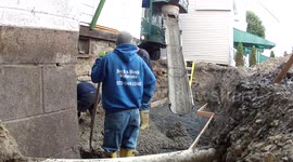 Pouring a cement footer and floor.