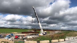 Crane lifting huge steel for a new bridge, short timelapse.