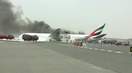 Evacuated passengers film plane on fire