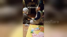 Newsflare Edit - Children cover their faces in nappy rash cream