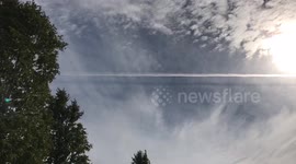 Airplane exhaust casting a shadow in the sky
