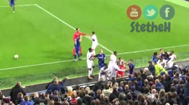 Everton fan tries to hit Lyon goalkeeper while holding his son