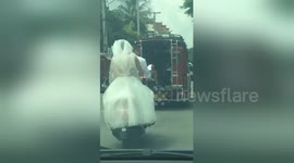 Bride riding pillion gets pulled over by police for not wearing helmet