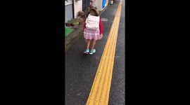 Schoolgirl gives stray cat a piggyback