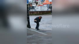 Inebriated man struggles to hold his beers