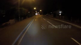 Motorists use pavement to avoid inconvenient diversion. Cyclists blocks motorists. One motorist gets out for argument. Cyclist then blocks pavement. Support from local residents