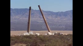 Dramatic demolition of enormous twin smoke stacks