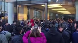 Apple employees cheer to welcome customers waiting for iPhone X in Beijing