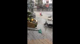 Typhoon Damrey residents scramble to pick up motorbikes after storm