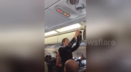 Air hostess struggles through safety routine as football fans make her laugh