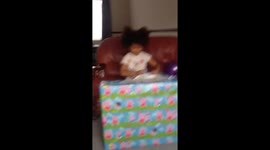 Little girl excitedly opens birthday present