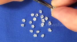 Man assembles 6mm Rubik's Cube puzzle