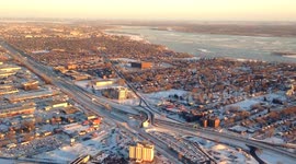 Aerial view during sunset of snow and ice covering Montreal & St-Laurent river