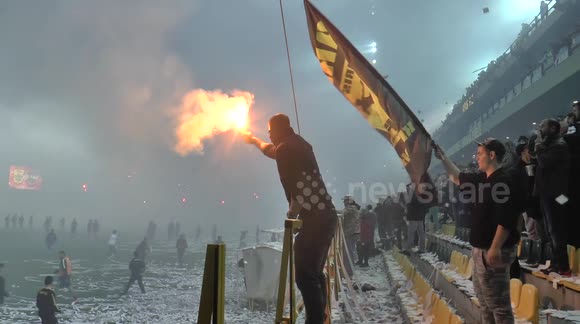 Fans of Greek side Aris announce their side's revival with pyrotechnics at Boca friendly
