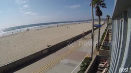 Two guys on powered skateboards collide.