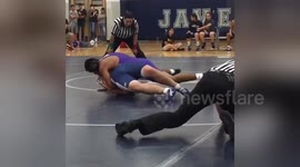 Wrestling referee makes CRAZY slide across mat