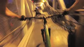 Skier crashes down stairs while biker follows and films