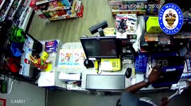 Police have released terrifying footage showing the moment a brave shopkeeper fended off an armed robber - with a SPANNER.