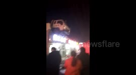 Driver's truck ends up on restaurant roof