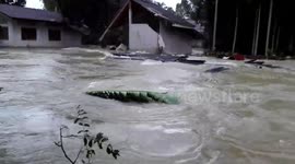 Father watches as Thailand flash flood destroys house