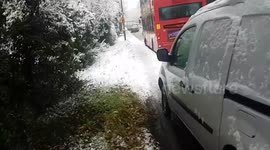Snow causes cars, bus and lorry to get stuck on a hill