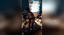 Baby takes out big brother on treadmill