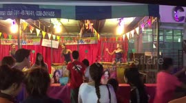 Bizarre dunking woman in water fairground game