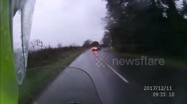 Driver drifts over to wrong side of road on a bend and just misses motorcyclist.