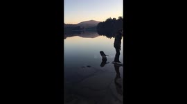 Boy stands on rock on river and then gets away without getting wet