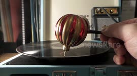 Sound artist plays 'Silent Night' on record player with Christmas bauble