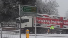 Lorry struggles on wrong side of dual carriageway, during heavy snow..