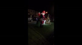 Woman tackles inflatable Santa at party