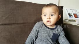 baby trying pomegranate juice for the first time