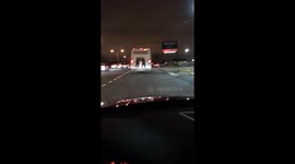 PILLAR-BOXED VERSION: Two kids hitching a ride on the back of a MTA bus